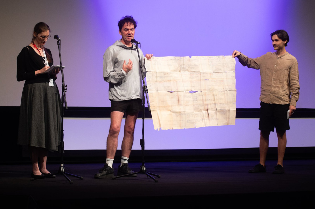 https://screenanarchy.com/assets/2026/07/interpreter-marie-pribylova-film-director-mark-cousins-and-moderator-jan-kinzl.jpg