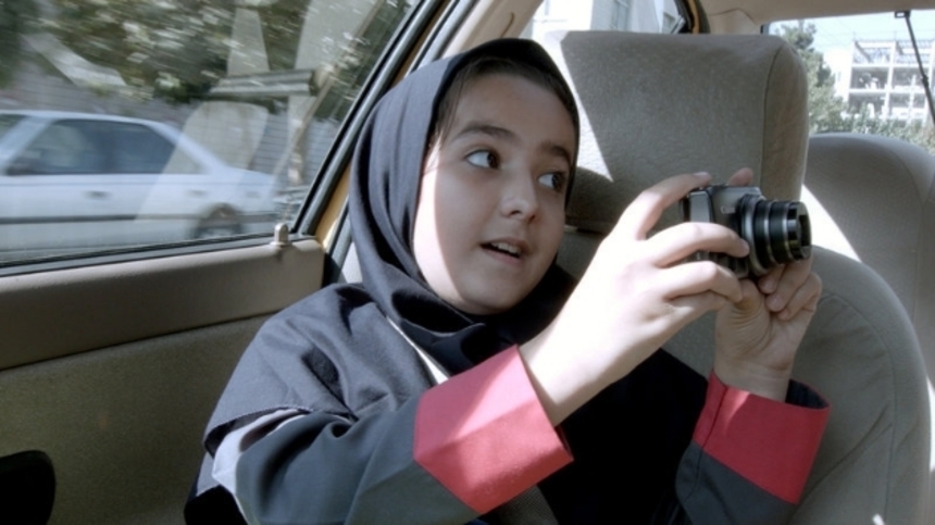 Review: Jafar Panahi, Once Again, Defies The Powers That Be With TAXI
